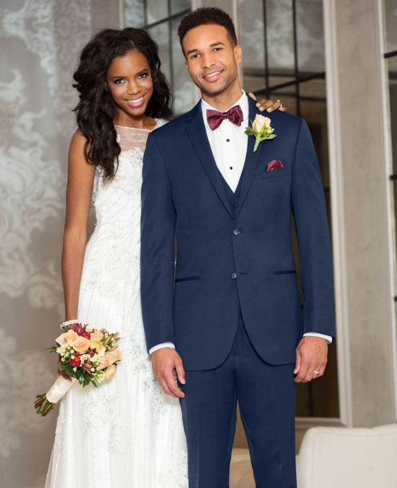 Сouple wearing a white gown and a black suit