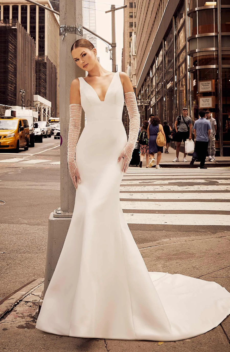 model is wearing a sleeveless lace fit and flare wedding dress