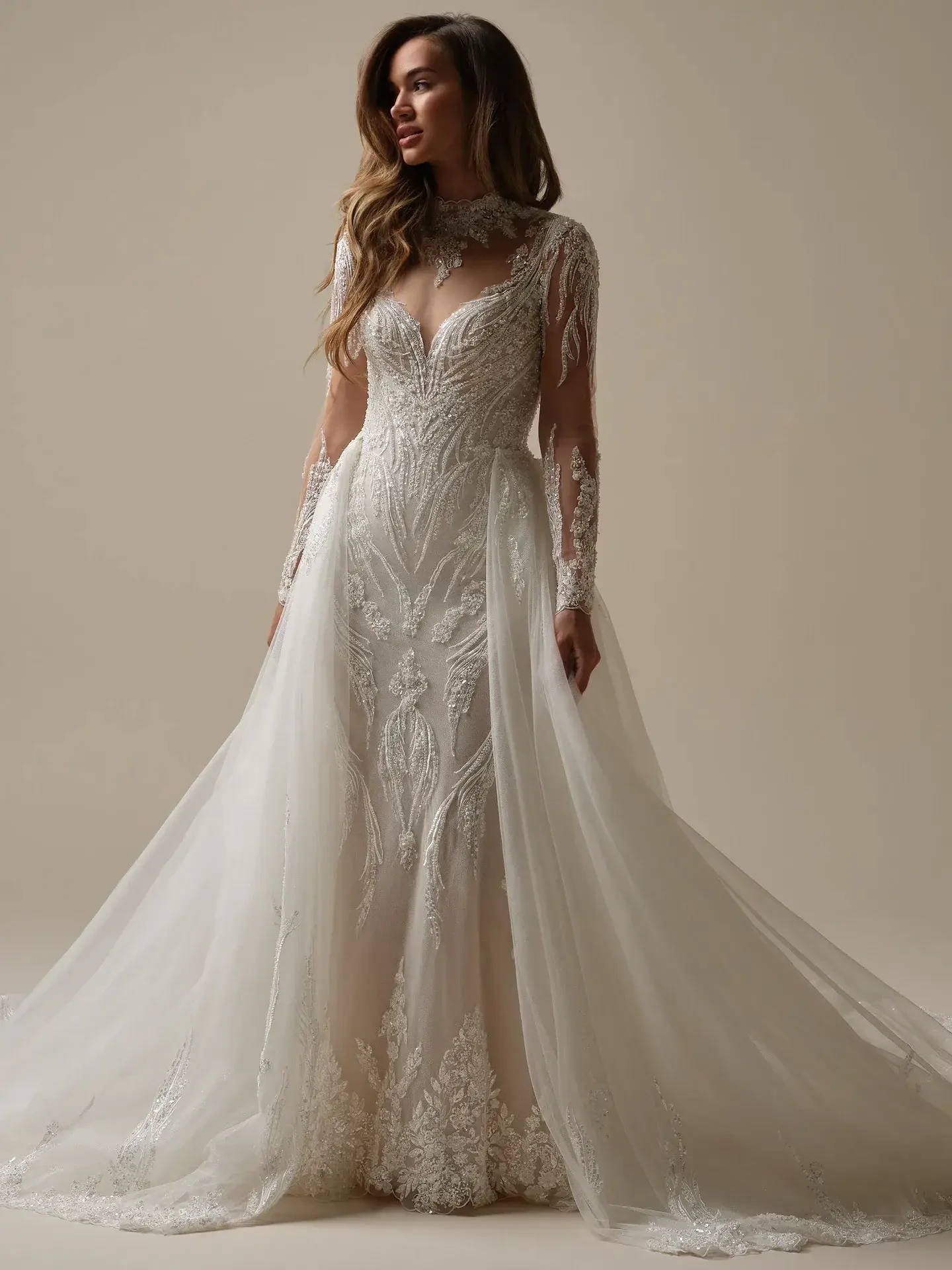 model is wearing a long sleeve bridal gown