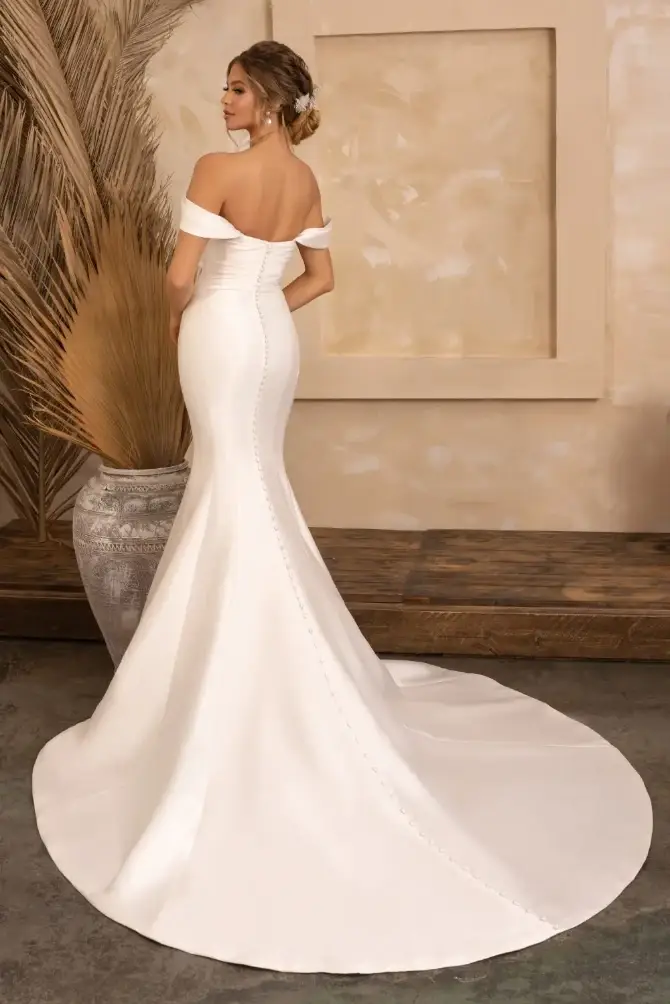 Model is wearing an off the shoulder mermaid wedding dress
