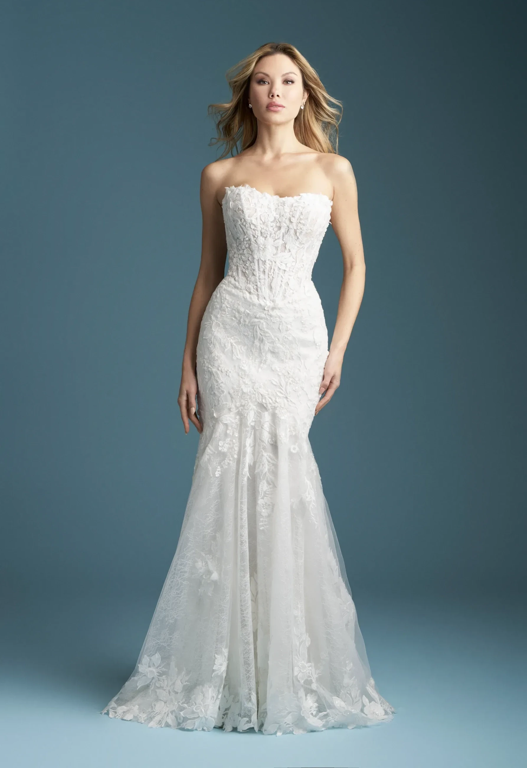 Model wearing a white gown by Allure Bridals