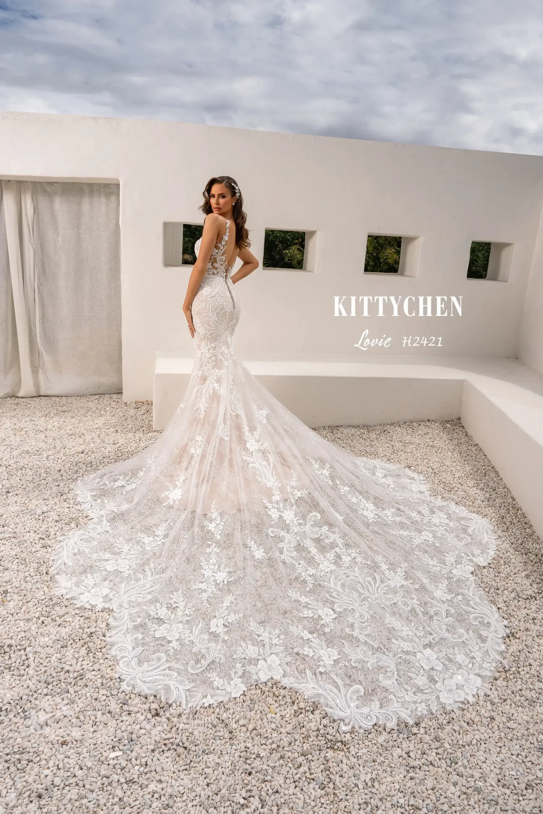 Model is wearing a trumpet wedding dress with a plunging neckline from kitty chen