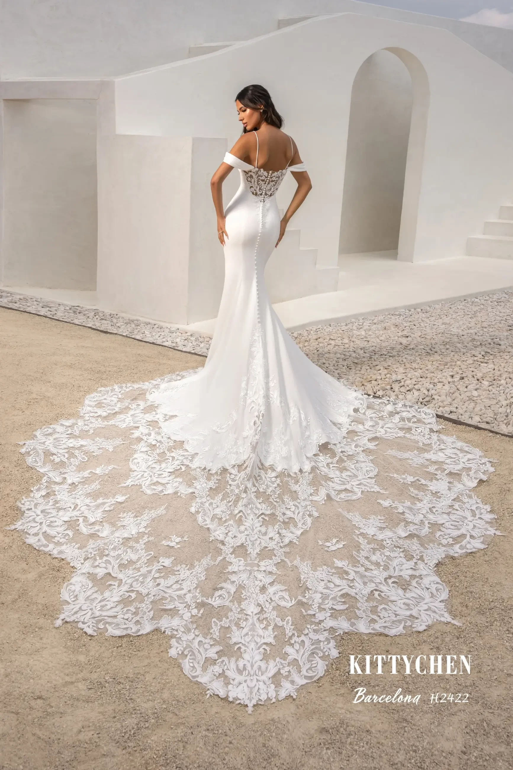 Model is wearing a fitted wedding dress with spaghetti straps and off the shoulder straps from kitty chen 