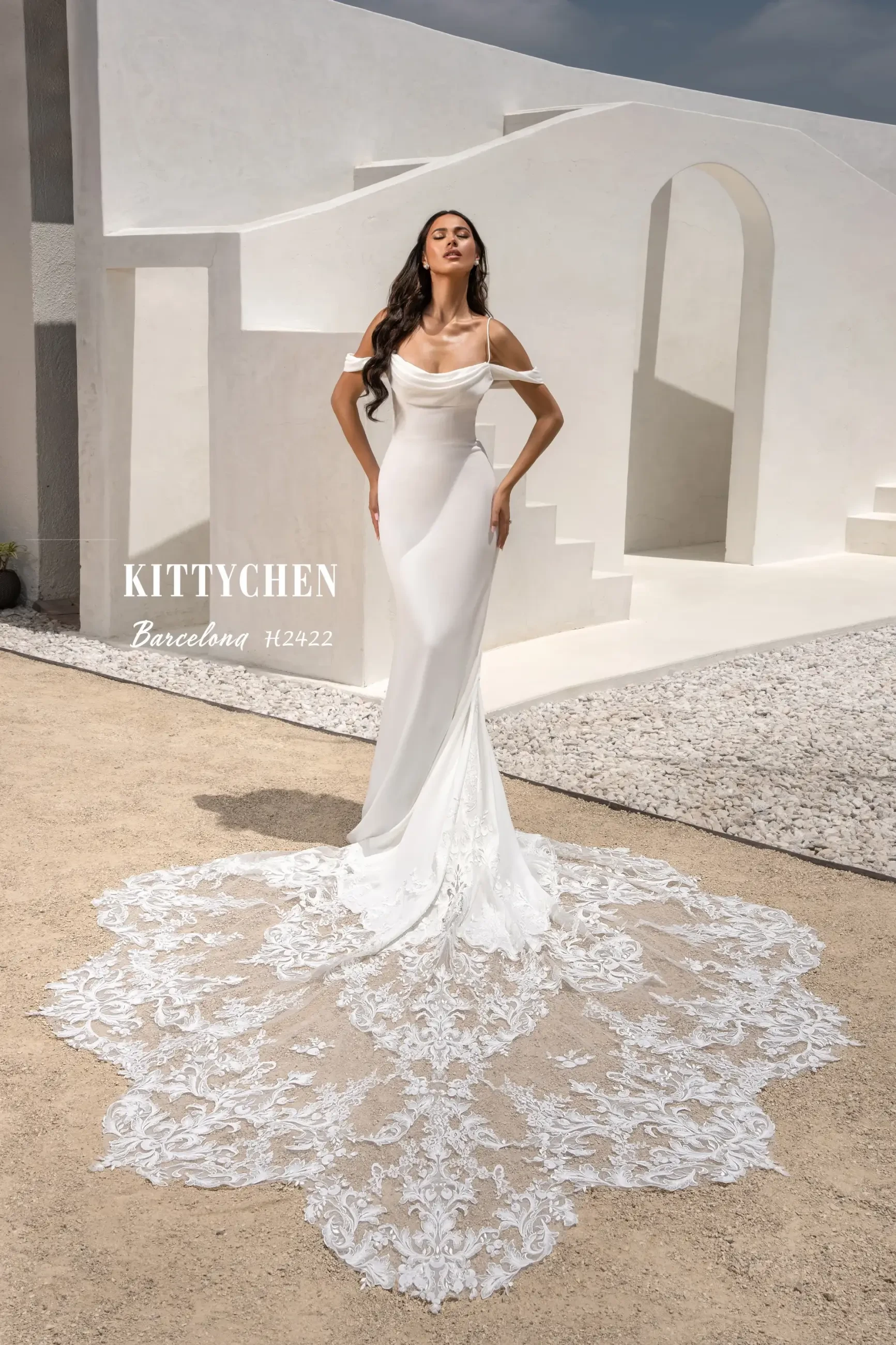 Model is wearing a fitted wedding dress with spaghetti straps and off the shoulder straps from kitty chen 