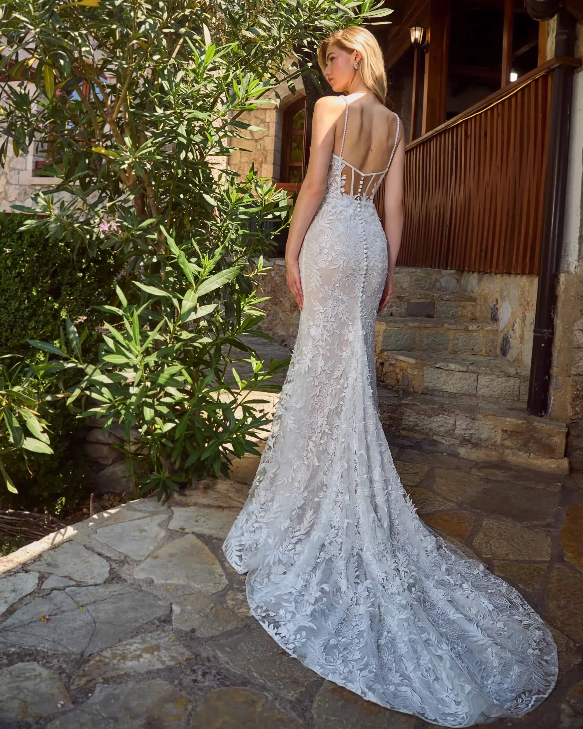 model is wearing a sleeveless floor length spaghetti strap bridal gown