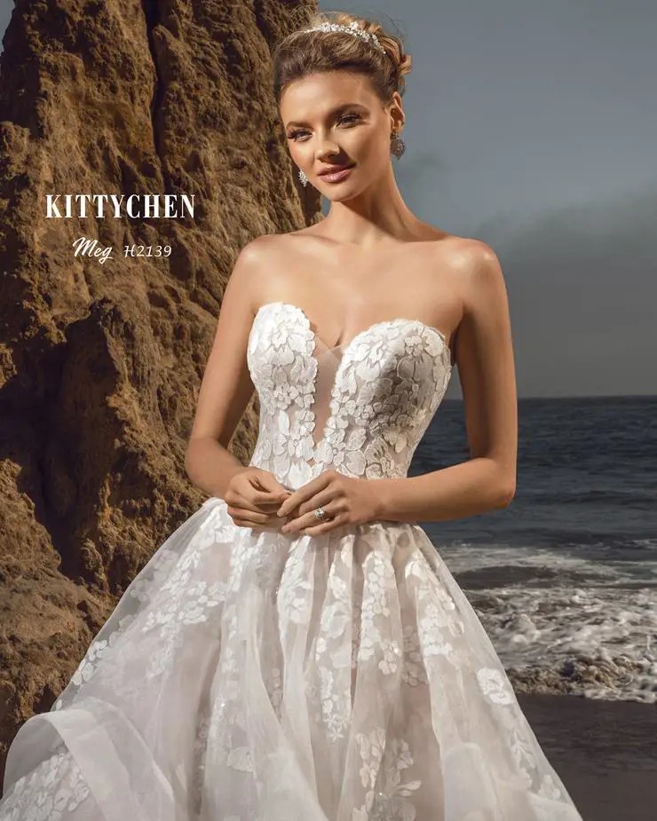 Model wearing a white gown by Kitty Chen