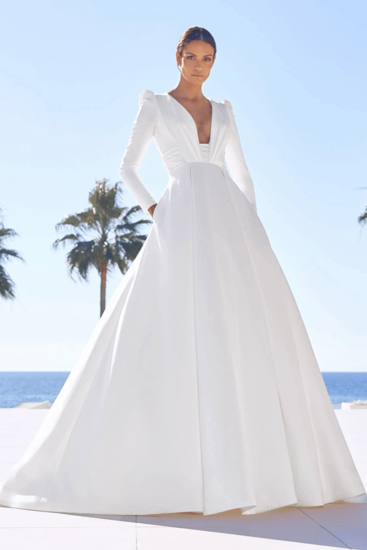 Model wearing a white gown by Pronovias. Mobile image
